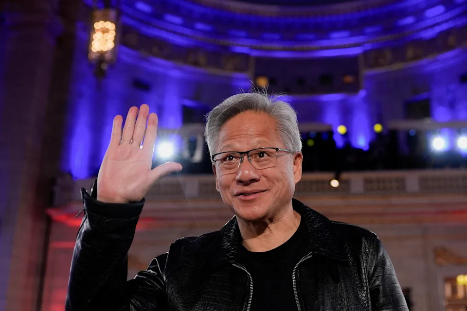 Nvidia CEO Jensen Huang gestures as President Trump delivers remarks during the